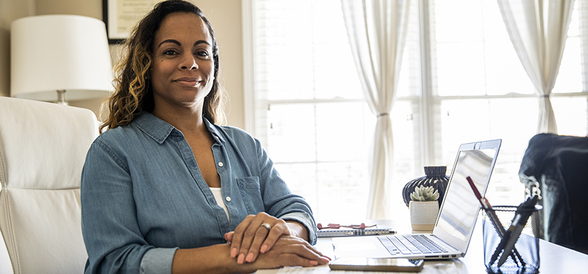 Woman at desk researching when should you get a mammogram