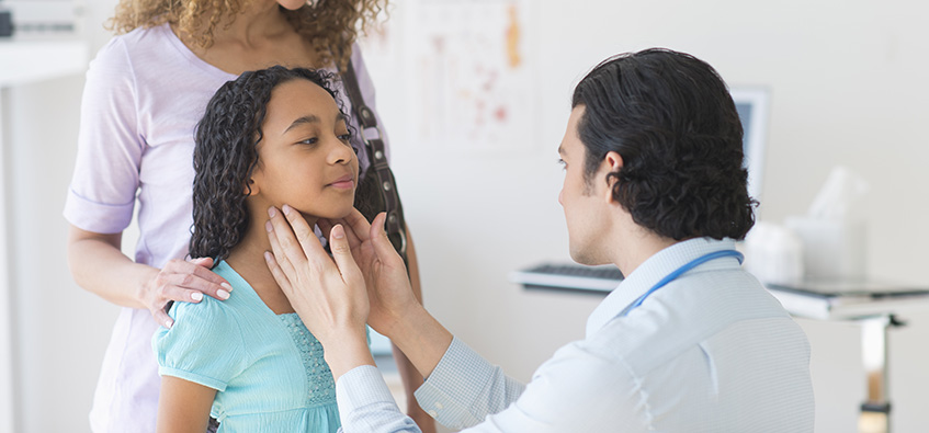 Pediatric doctor examines child for airway reconstruction