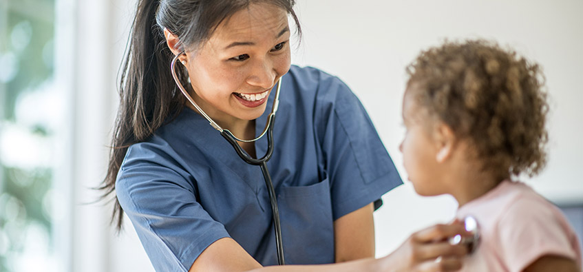 Child patient with umbilical hernia examined by doctor