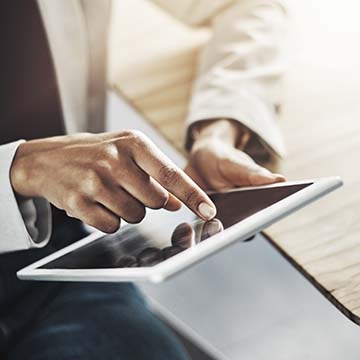 Woman using mobile device to download free Beaumont heart health guide