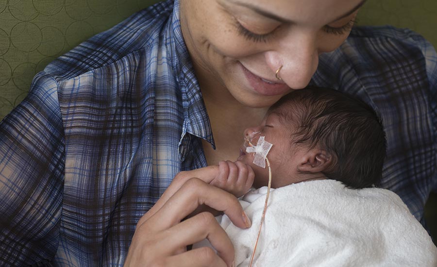 Mother holds her newborn baby at Beaumont