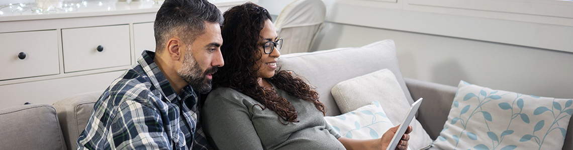 Happy couple using myBeaumontChart to schedule an appointment