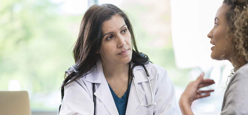 Internal medicine doctor speaks to patient at Beaumont