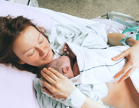 A mother holding her newborn baby at Beaumont hospital